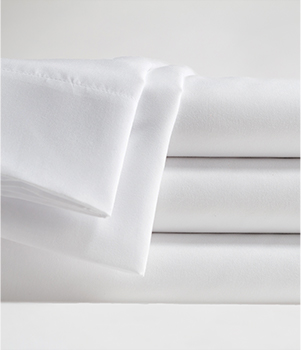 A stack of folded white sheets on a grey background. Another folded sheet is draped over the left side of the stack.