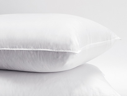 Two Garnett Fill pillows, one stacked on top of the other sit on a white background.